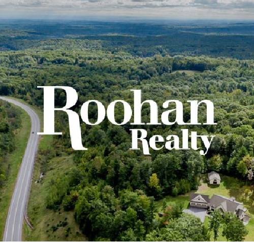 Roohan Realty logo with trees in the background.