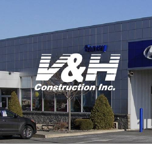 V&H Construction logo with a car dealership in the background.