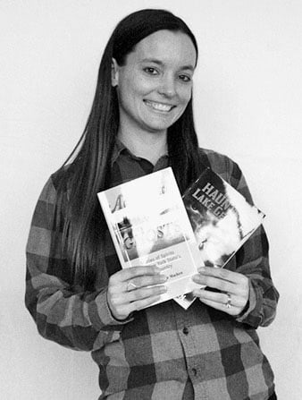 Erin Nudi holding books