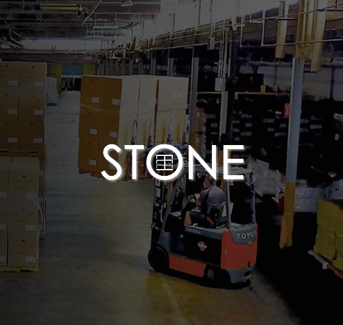 Stone Warehousing logo with their warehouse in the background.