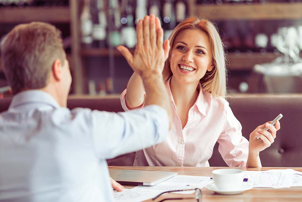 Employees high-fiving each other.