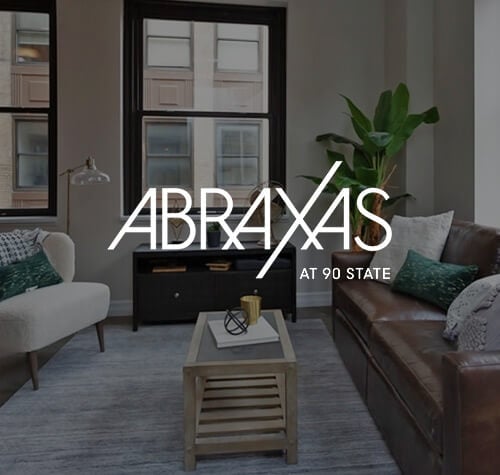 Abraxas Apartments logo with one of their apartments in the background.