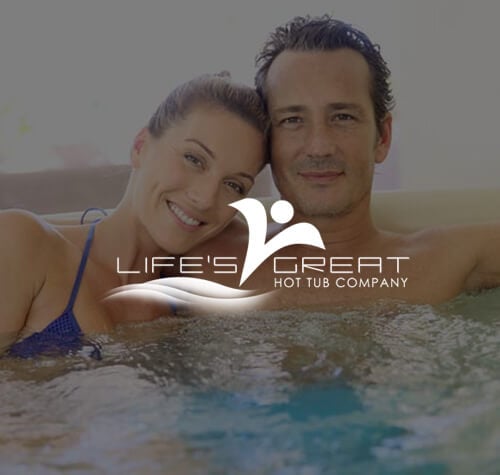 Life's Great Hot Tub Company logo with a couple enjoying their hot tub in the background.