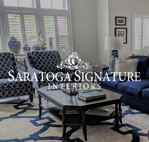 Saratoga Signature Interiors with a blue and white themed living room in the background.