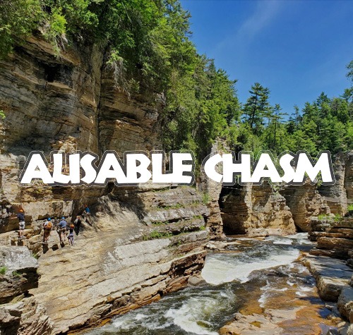 Ausable Chasm logo with a tour group hiking in the background.