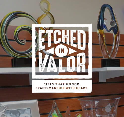 Etched in Valor logo with some of their works in the background.