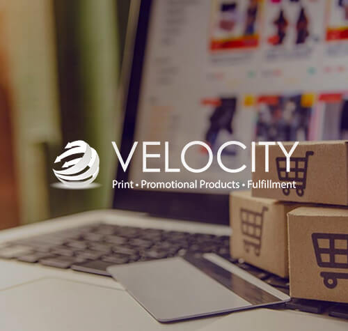Velocity Print logo with a laptop and card in the background.