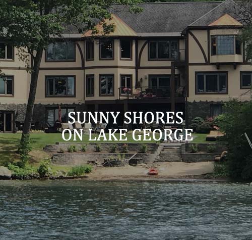 Sunny Shores on Lake George logo with the Lake George waterfront in the background.