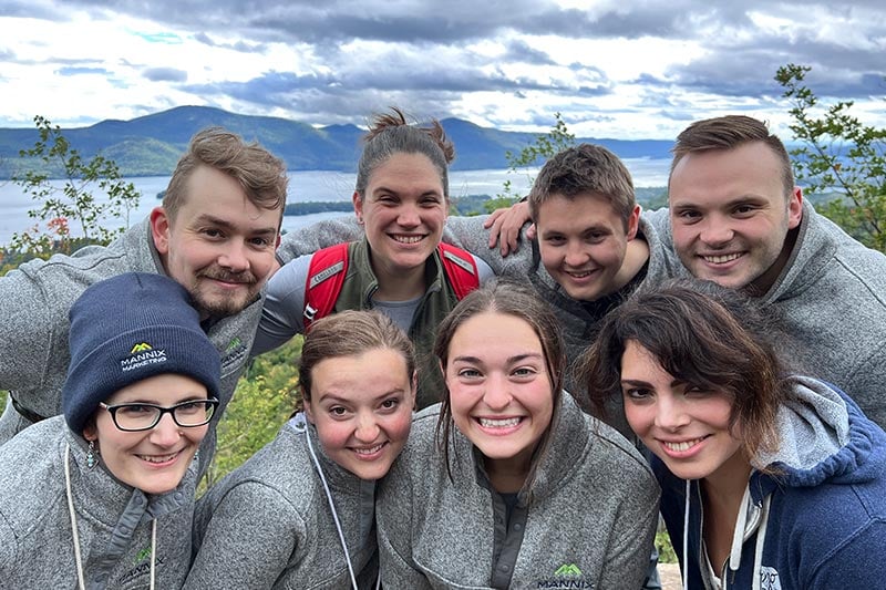 Employees of Mannix Marketing posing for a picture on their hike during their company retreat.