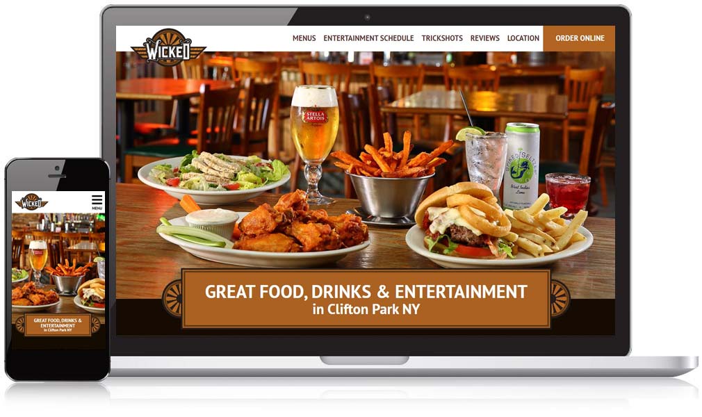 wicked eatery homepage displayed on a computer screen & phone